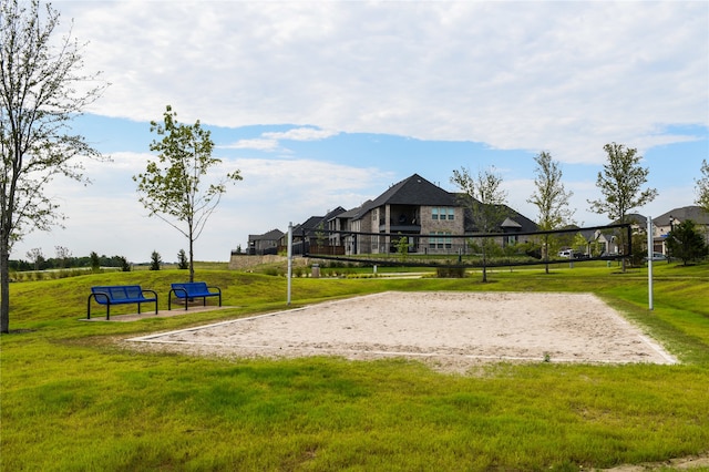 surrounding community featuring volleyball court and a yard