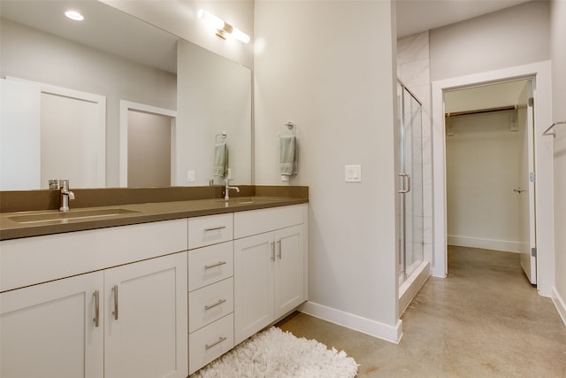 bathroom featuring vanity, a shower with shower door, and concrete flooring