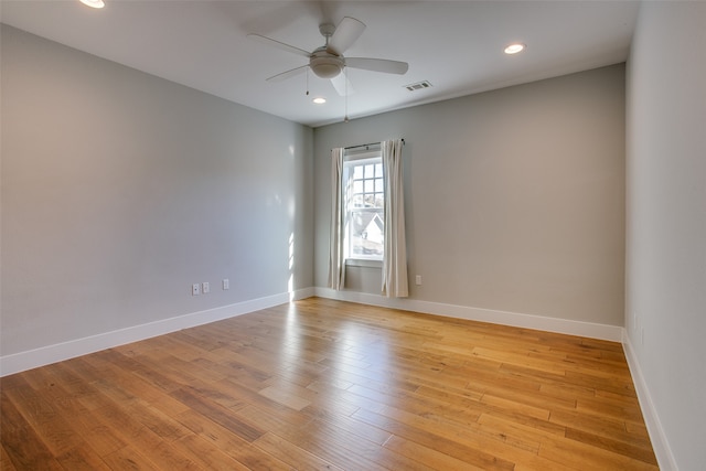 unfurnished room with light wood-type flooring and ceiling fan