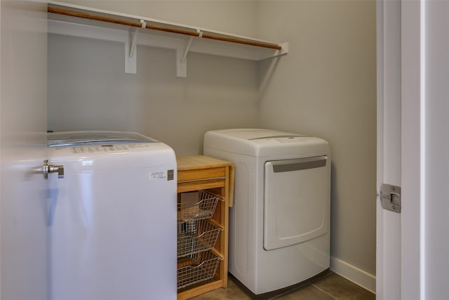 laundry room featuring tile patterned floors and washer and clothes dryer