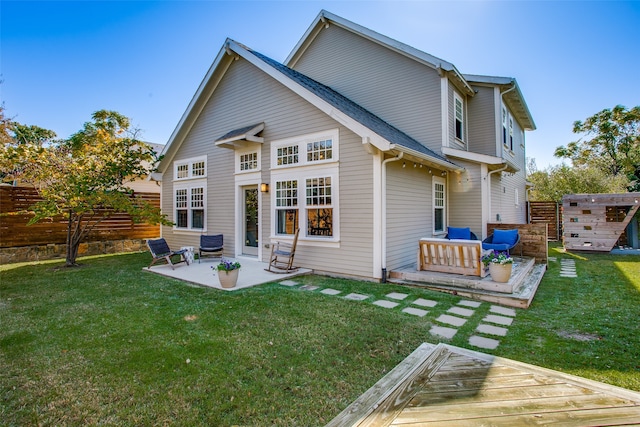 back of property featuring a lawn, a patio, and an outdoor hangout area