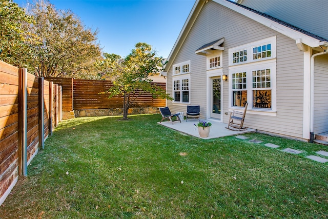 rear view of house featuring a lawn and a patio