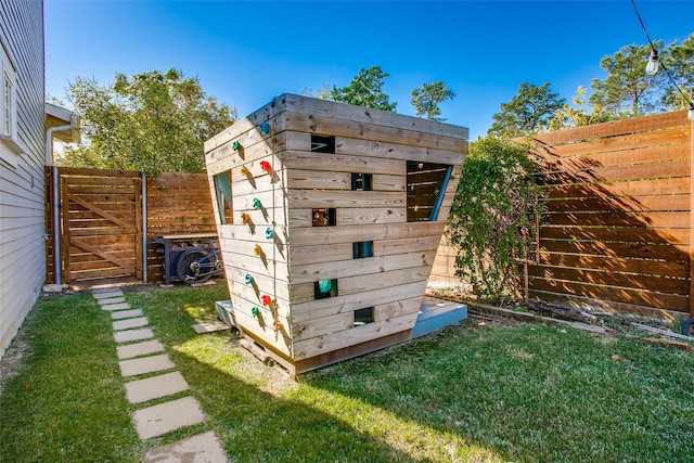 view of outbuilding featuring a lawn