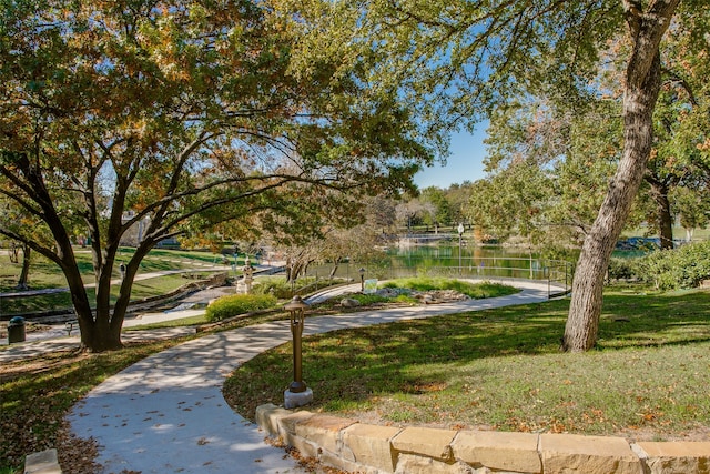 view of community with a lawn and a water view