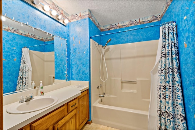 bathroom featuring vanity, shower / bath combo with shower curtain, and a textured ceiling