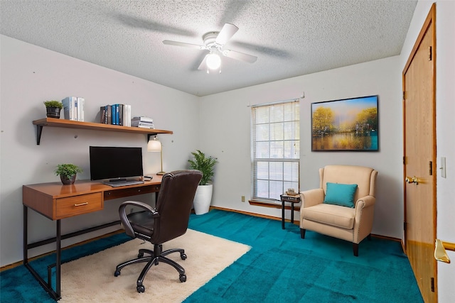 carpeted office with a textured ceiling and ceiling fan