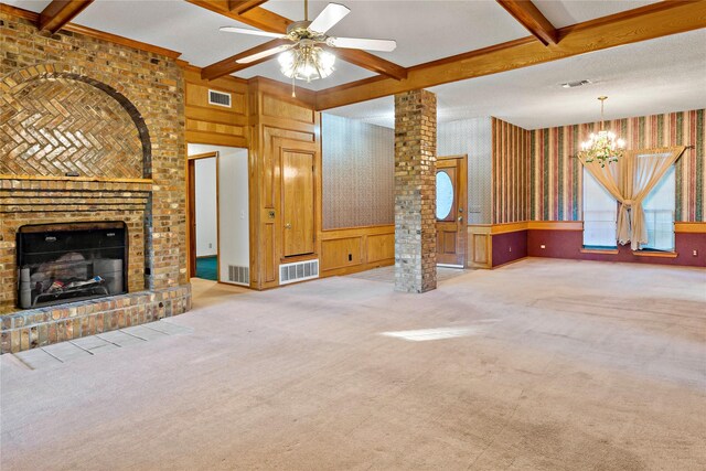 living room featuring wooden walls, ceiling fan, a brick fireplace, beam ceiling, and coffered ceiling