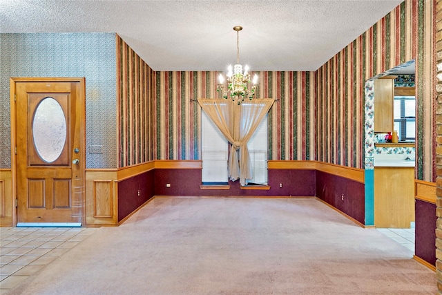 interior space featuring a notable chandelier and a textured ceiling