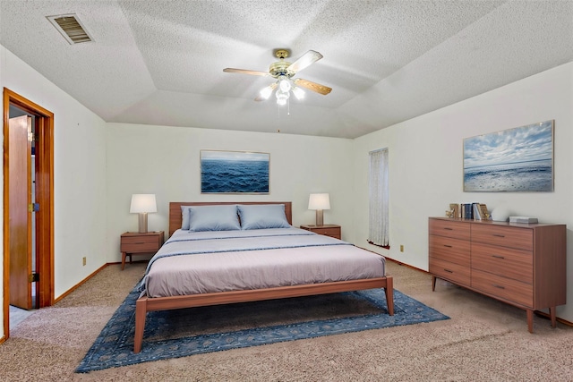 carpeted bedroom with lofted ceiling, ceiling fan, and a textured ceiling