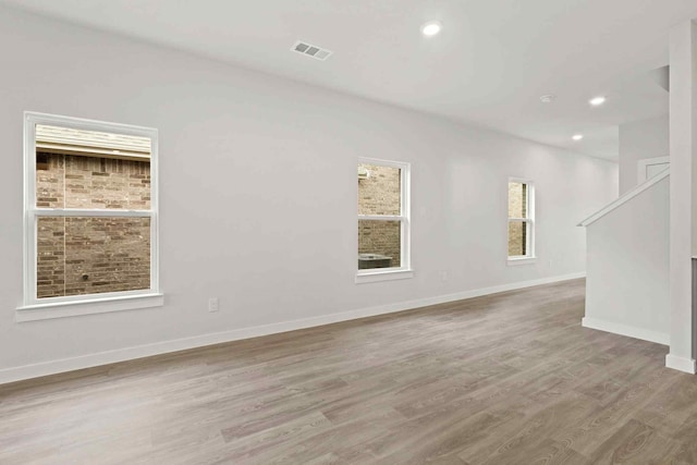 unfurnished room with light hardwood / wood-style floors