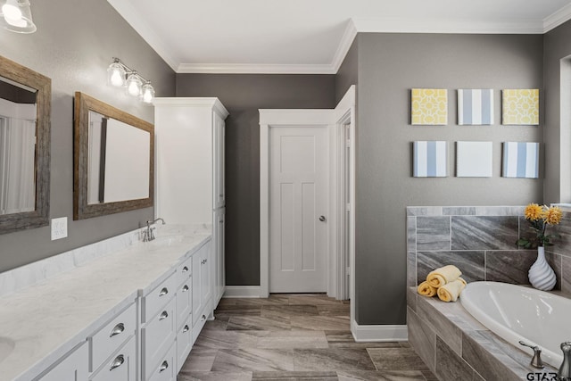 bathroom featuring tiled tub, crown molding, and vanity