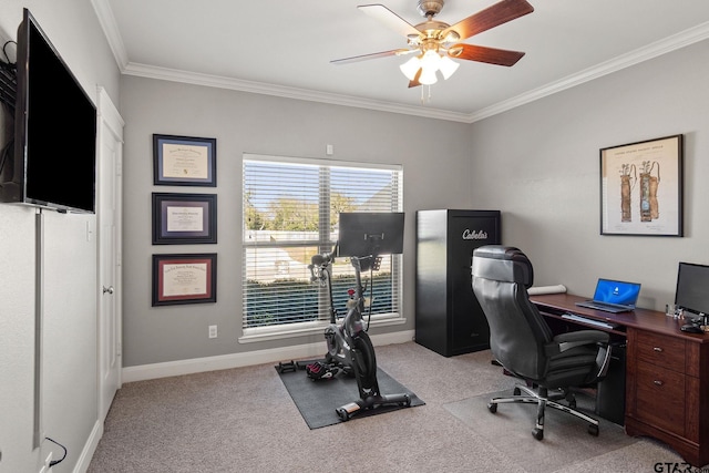 carpeted home office featuring ceiling fan and ornamental molding