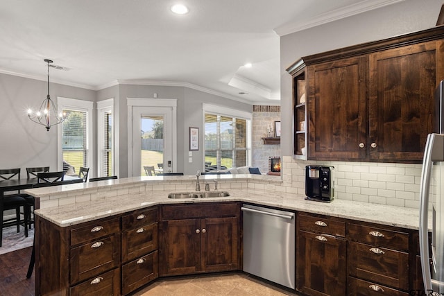 kitchen with a healthy amount of sunlight, sink, kitchen peninsula, and stainless steel appliances