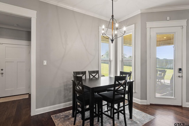 dining space featuring ornamental molding, dark wood-type flooring, and a notable chandelier