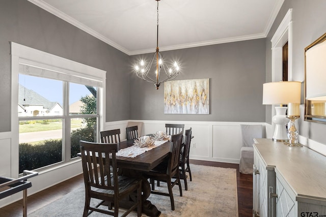 dining space with a chandelier, dark hardwood / wood-style flooring, and ornamental molding