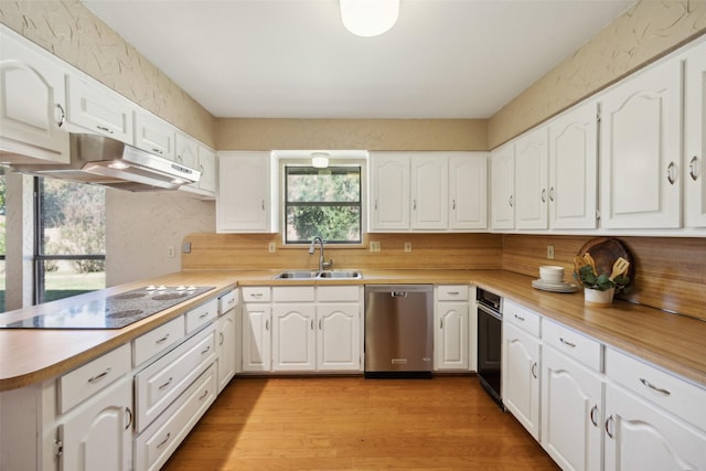 kitchen with dishwasher, sink, light wood-type flooring, a healthy amount of sunlight, and white cabinetry