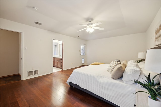 bedroom with dark hardwood / wood-style flooring, ensuite bath, and ceiling fan