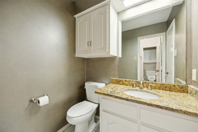 bathroom featuring vanity and toilet