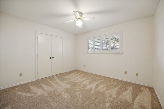 unfurnished bedroom with carpet, a closet, and ceiling fan