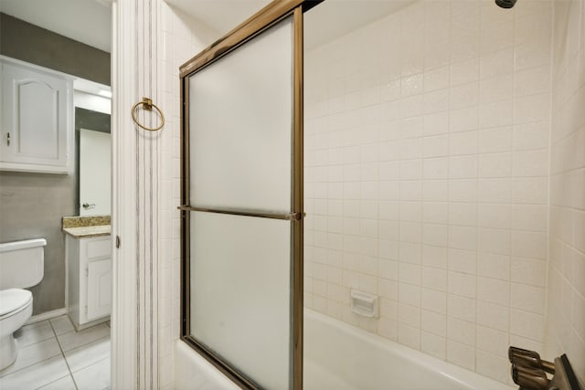 full bathroom featuring tile patterned floors, vanity, toilet, and enclosed tub / shower combo