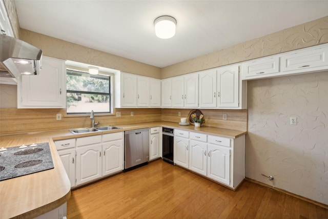 kitchen featuring dishwasher, sink, light hardwood / wood-style floors, white cabinets, and exhaust hood