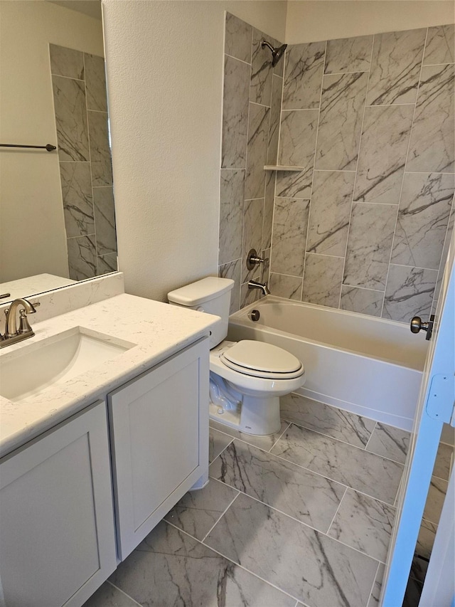 full bathroom with vanity, toilet, and tiled shower / bath