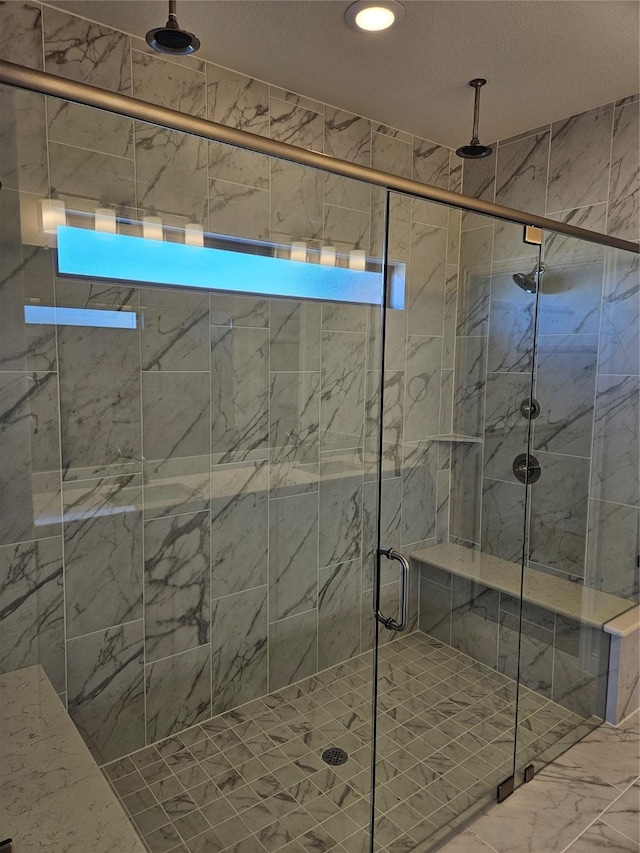 bathroom featuring a shower with shower door