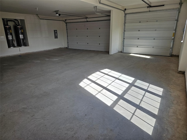 garage with a garage door opener, electric panel, and electric water heater