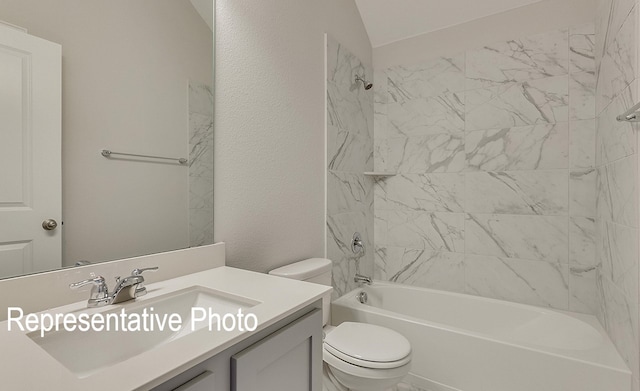 full bathroom featuring vanity, toilet, tiled shower / bath, and vaulted ceiling