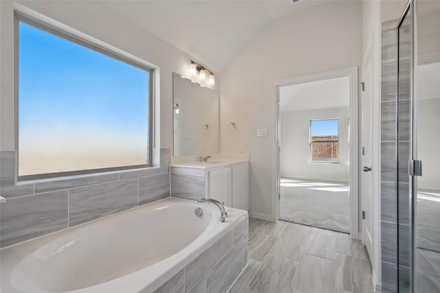 full bathroom featuring lofted ceiling, a garden tub, vanity, and an enclosed shower