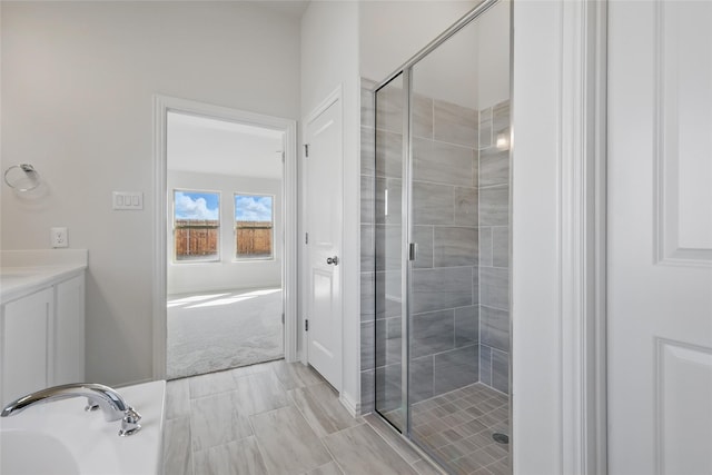 full bathroom featuring a stall shower and vanity