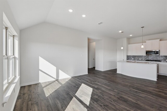 empty room with carpet floors and lofted ceiling