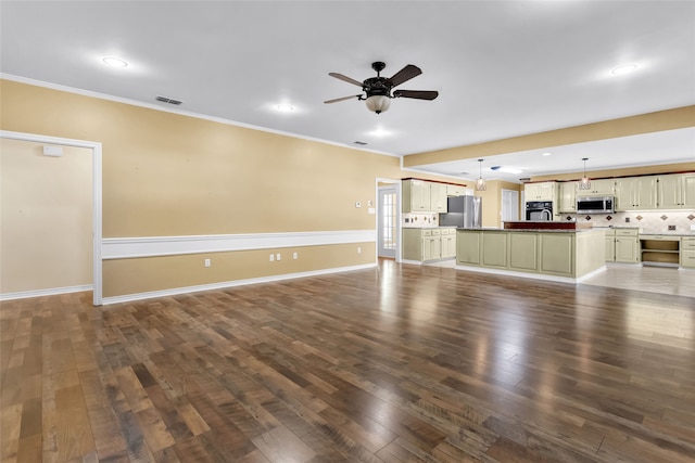 unfurnished living room featuring hardwood / wood-style flooring, ceiling fan, and crown molding