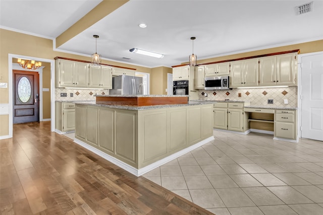 kitchen with a kitchen island, stainless steel appliances, and hanging light fixtures