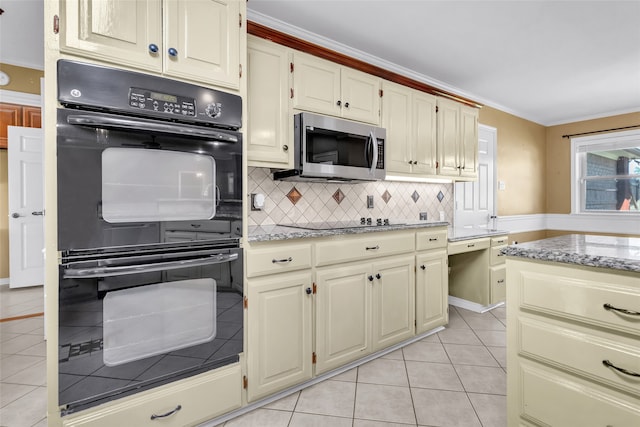 kitchen featuring light stone counters, double oven, crown molding, decorative backsplash, and light tile patterned floors