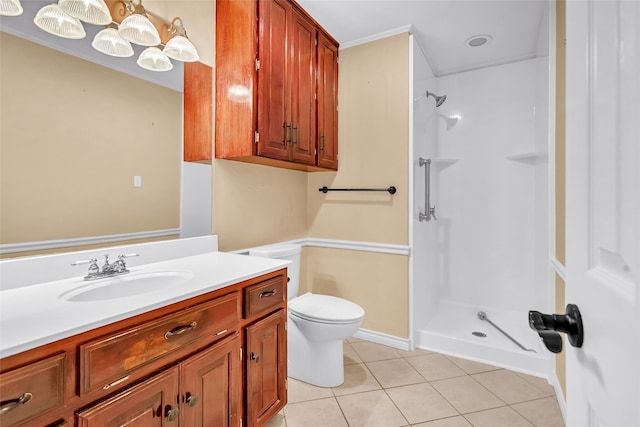 bathroom with toilet, vanity, tile patterned floors, and walk in shower