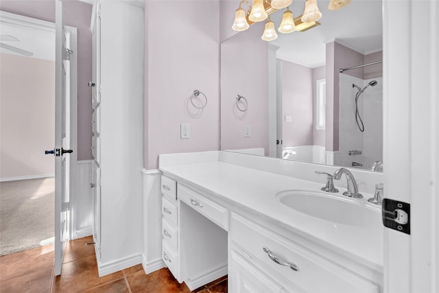 bathroom with tile patterned flooring, vanity, and crown molding