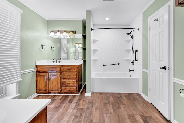 bathroom featuring vanity, ornamental molding, tiled shower / bath combo, and hardwood / wood-style flooring