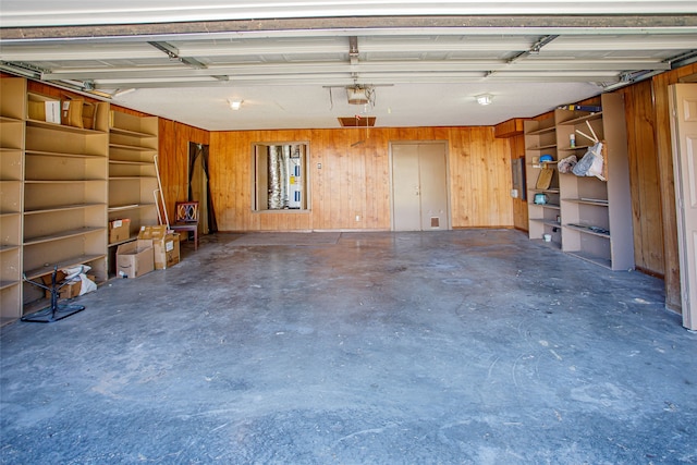 garage featuring wooden walls and a garage door opener