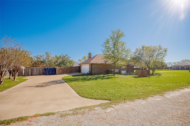 ranch-style house featuring a garage and a front lawn