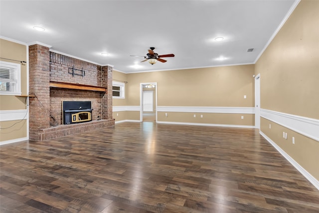 unfurnished living room with dark hardwood / wood-style flooring, a brick fireplace, ceiling fan, and ornamental molding