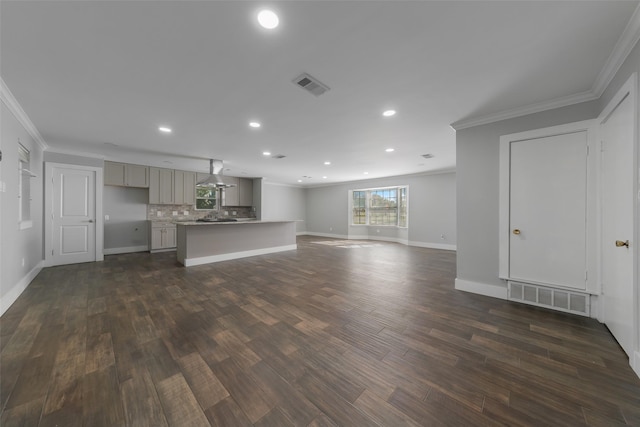 unfurnished living room with dark hardwood / wood-style flooring and crown molding