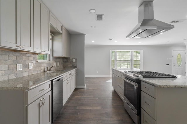 kitchen featuring light stone counters, stainless steel appliances, dark wood-type flooring, sink, and range hood