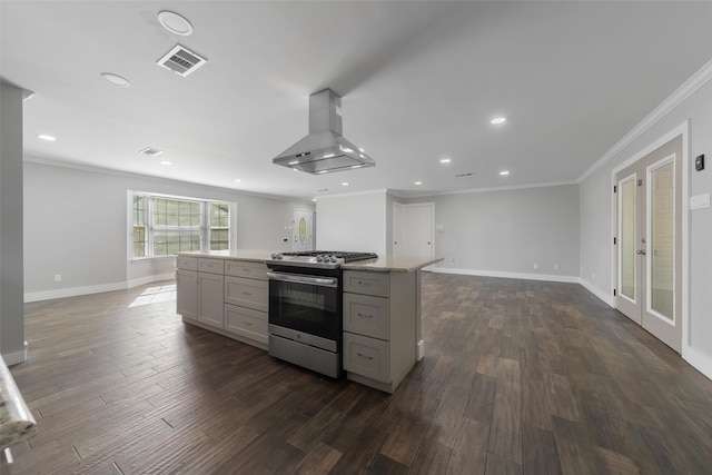 kitchen with gray cabinetry, stainless steel range, crown molding, exhaust hood, and dark hardwood / wood-style floors