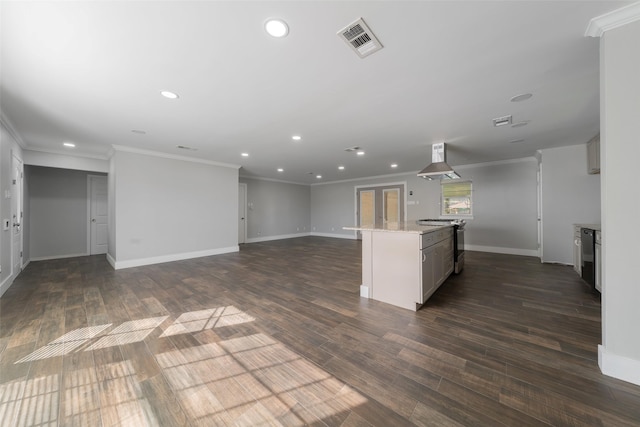 kitchen featuring light stone counters, dark hardwood / wood-style flooring, ventilation hood, crown molding, and a kitchen island