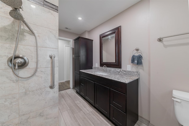 bathroom featuring vanity, hardwood / wood-style flooring, and toilet