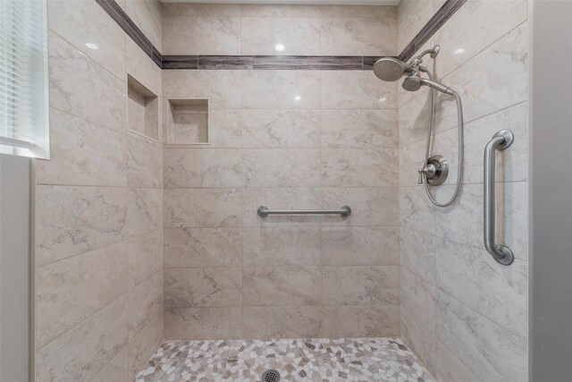 bathroom with a tile shower