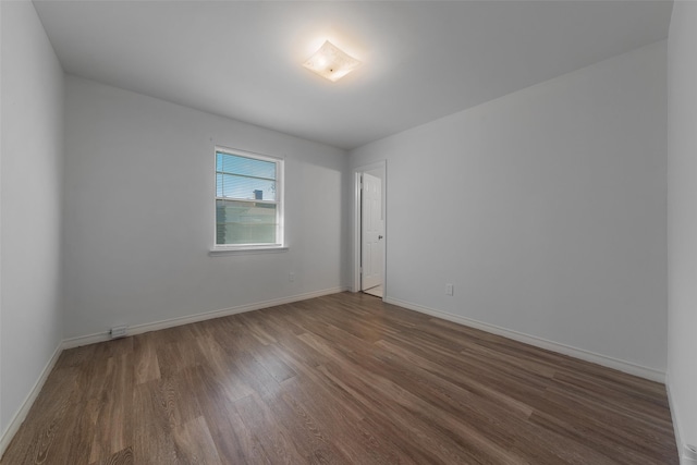 empty room with dark wood-type flooring