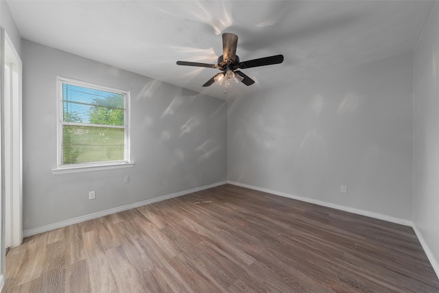 empty room featuring ceiling fan and hardwood / wood-style flooring