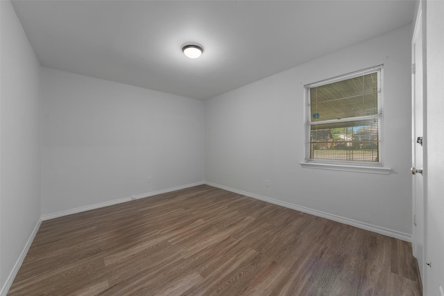 spare room featuring dark wood-type flooring